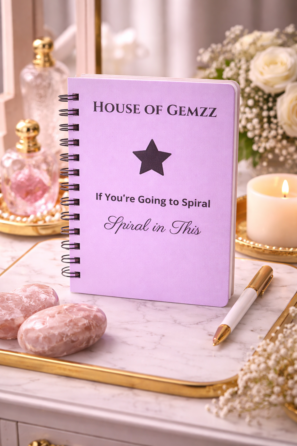 Lavender House of Gemzz Spiral in Style Star Edition journal on marble tray with gold accents, candle, pen, and soft luxury decor flat lay