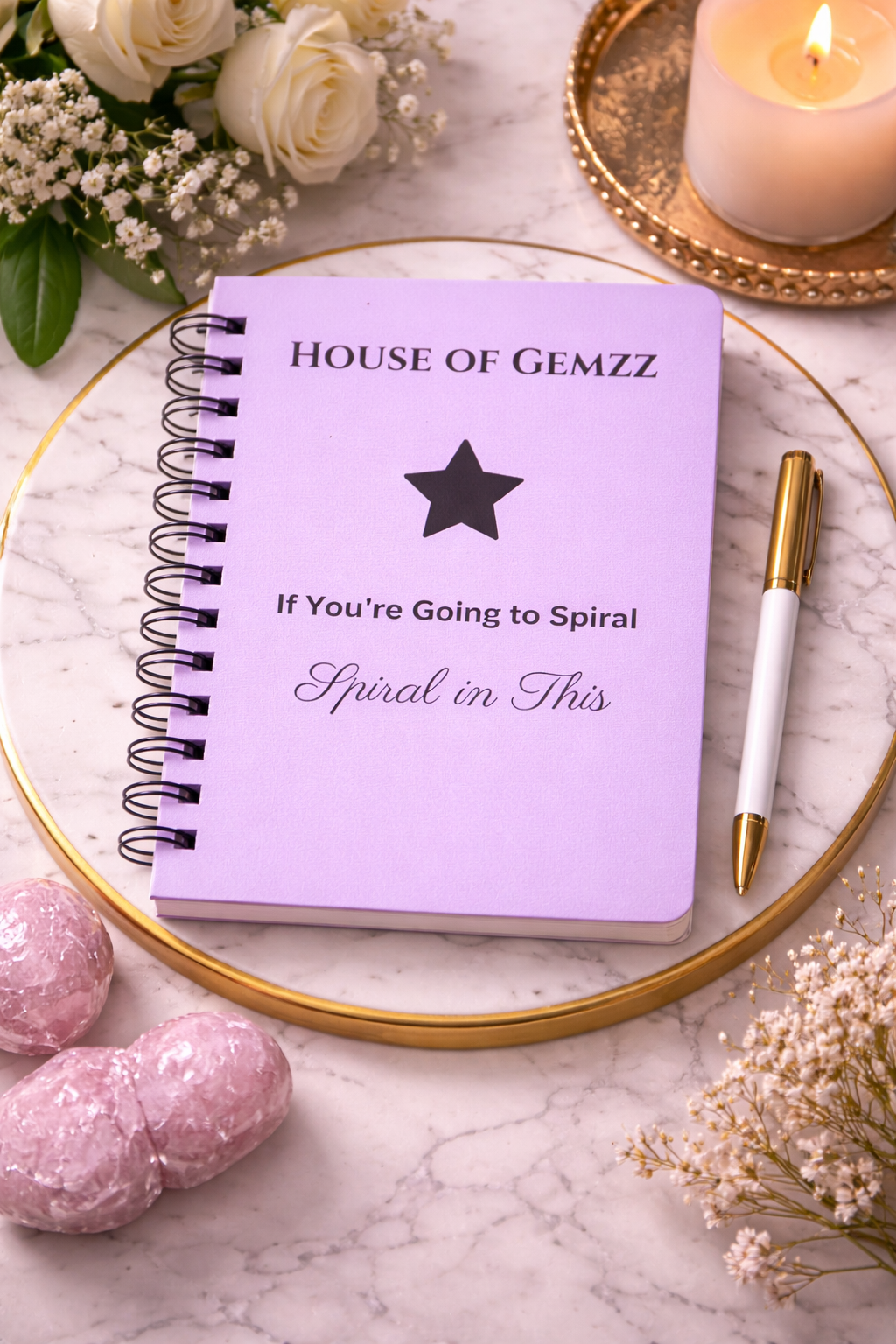 Lavender House of Gemzz Spiral in Style Star Edition journal on marble tray with gold accents, candle, pen, and soft luxury decor flat lay
