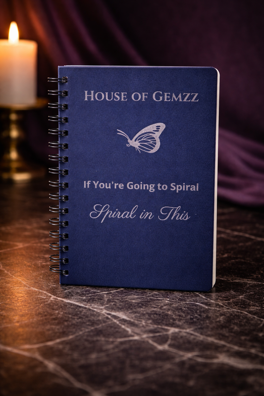 Navy blue spiral journal with silver butterfly design styled with candles and crystals, luxury self-care aesthetic journal by House of Gemzz