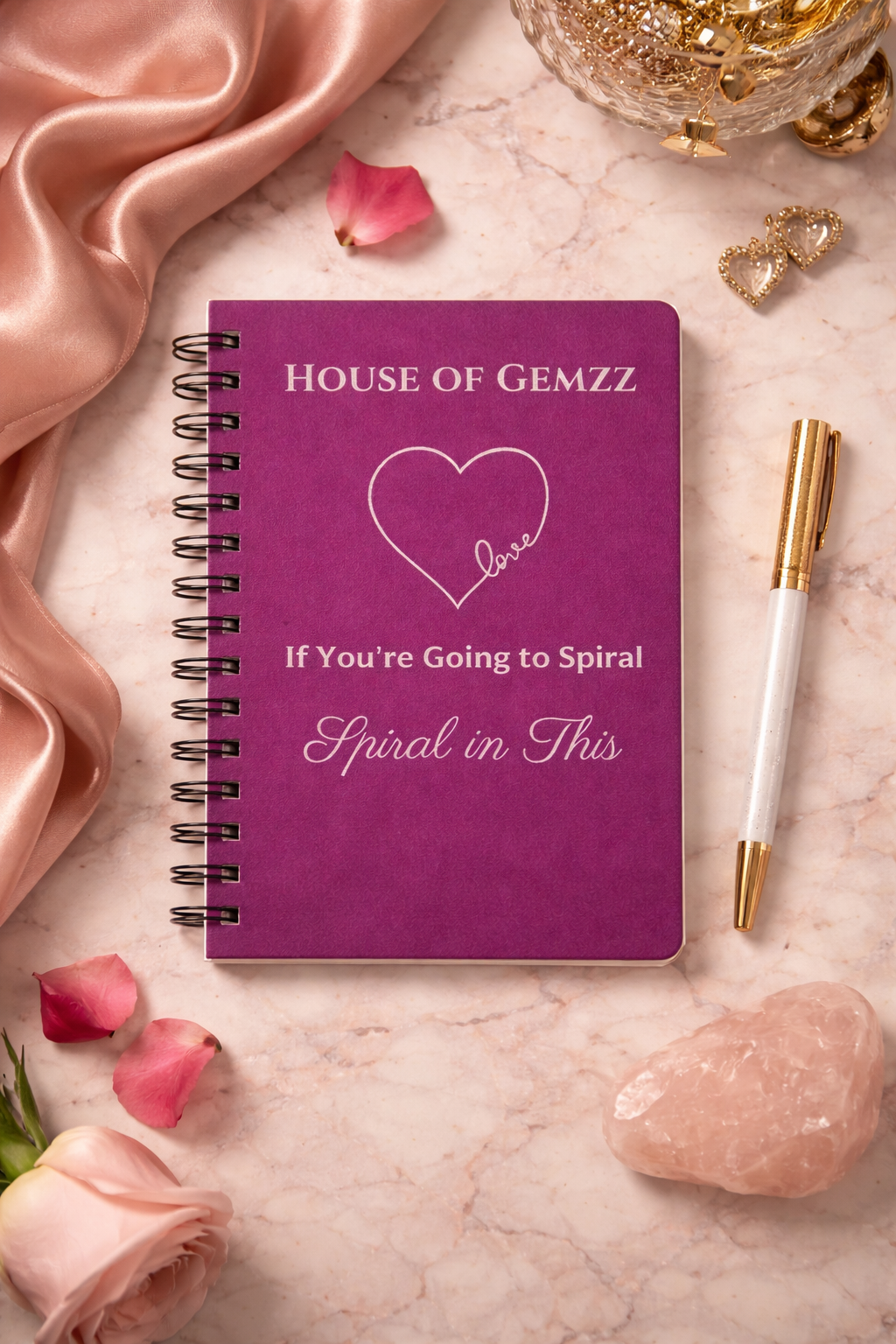 House of Gemzz Tyrian purple spiral journal with silver love design in flat lay with pen and rose quartz for manifestation journaling and self-love writing
