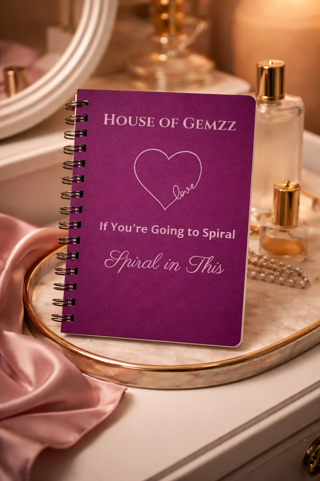 House of Gemzz Tyrian purple spiral journal with silver love design displayed on luxury vanity with perfume for self-care and intentional writing