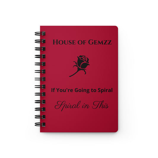 Red notebook with 'House of Gemzz' branding and text on a white background